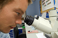 Image of person with microscope